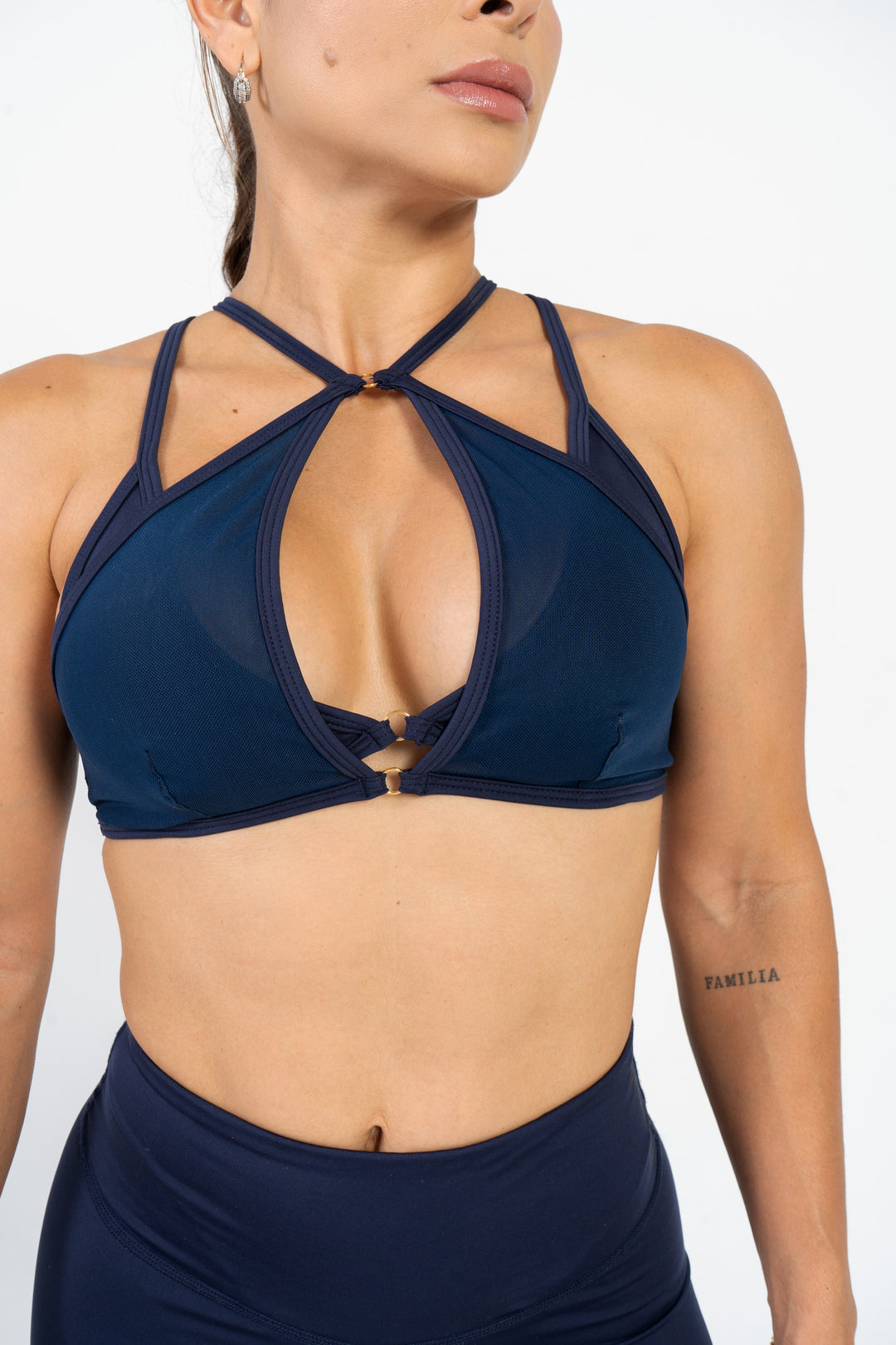 Navy blue sports bra and shorts on a person against a white background 