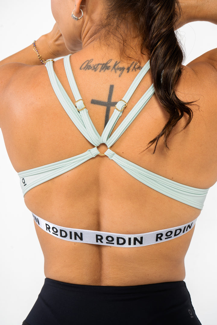 Person wearing a mint sports bra with &