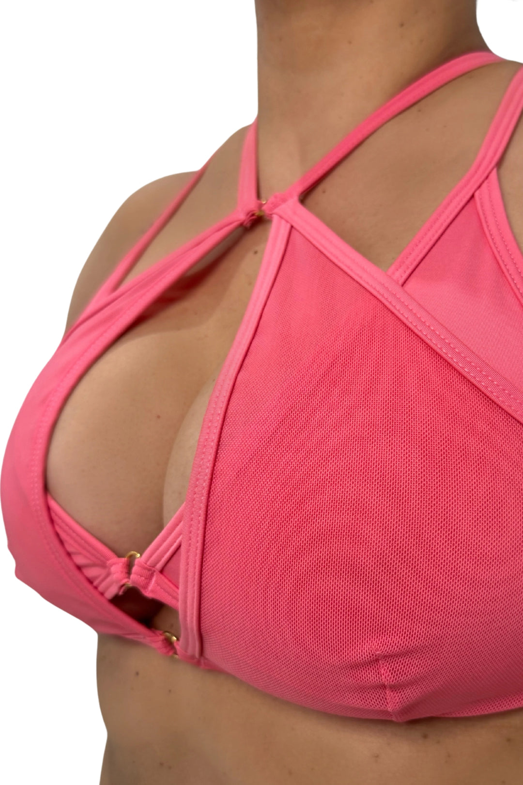 Close-up of a rose pink sports bra with criss-cross straps on a white background #color_rose