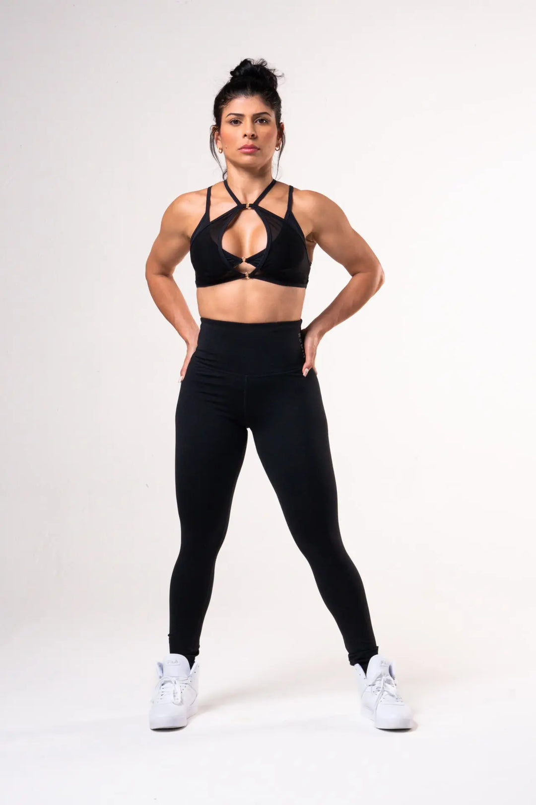 Woman wearing the Honey sport bra adjustable of color black#color_black