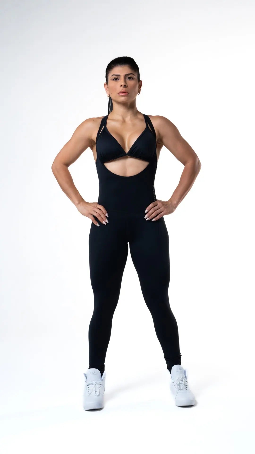 Woman wearing the Luna long bodysuit of medium compression and color black#color_black