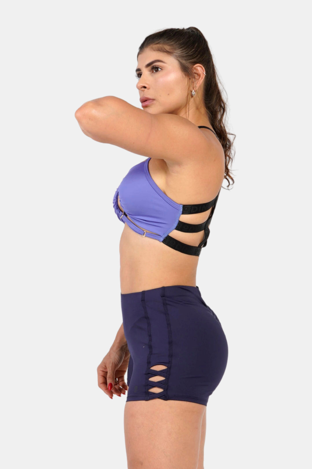Woman wearing a blue Sports bra top against a white background #color_blue-iris