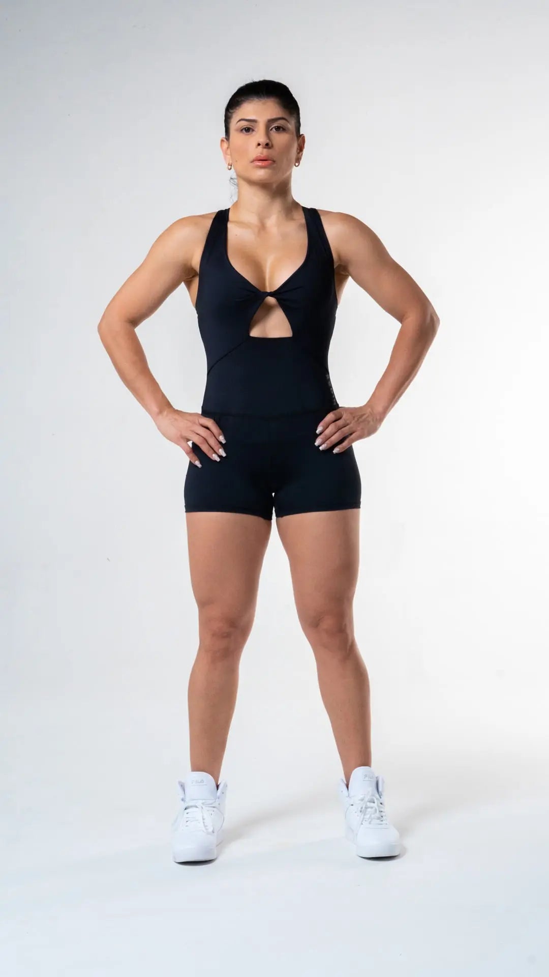 Woman wearing the Molly short bodysuit of medium compression and color black#color_black