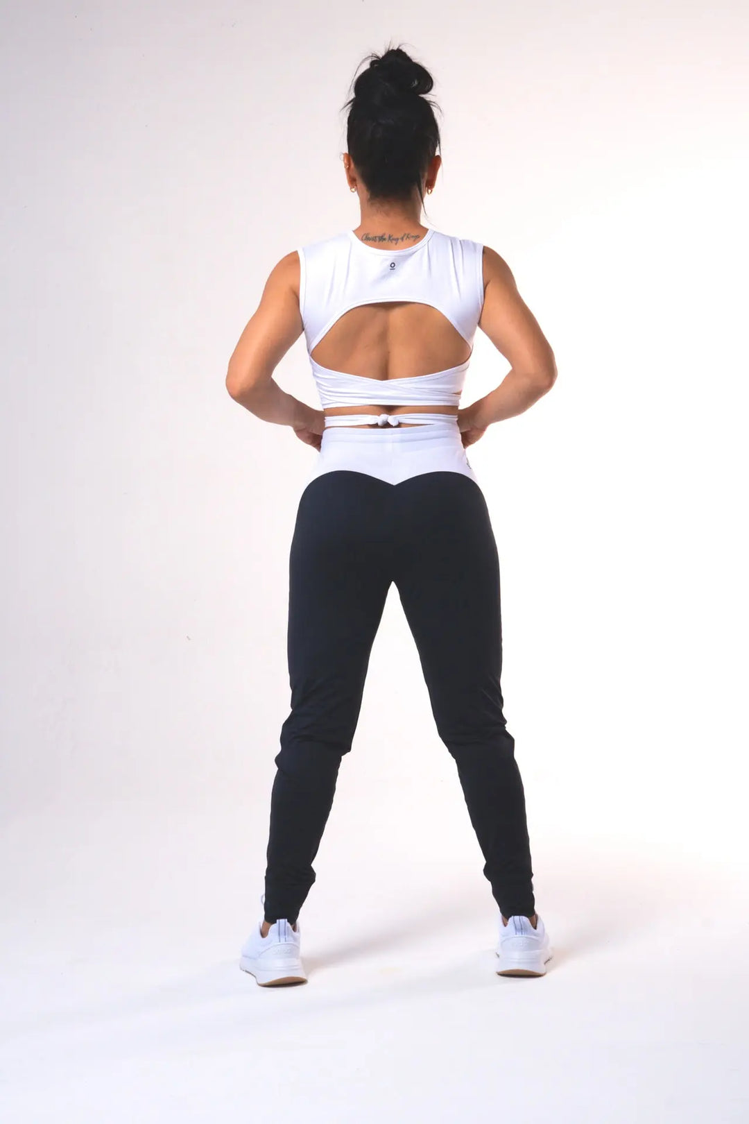 Woman wearing the Nikkie crop top functional of color white#color_white