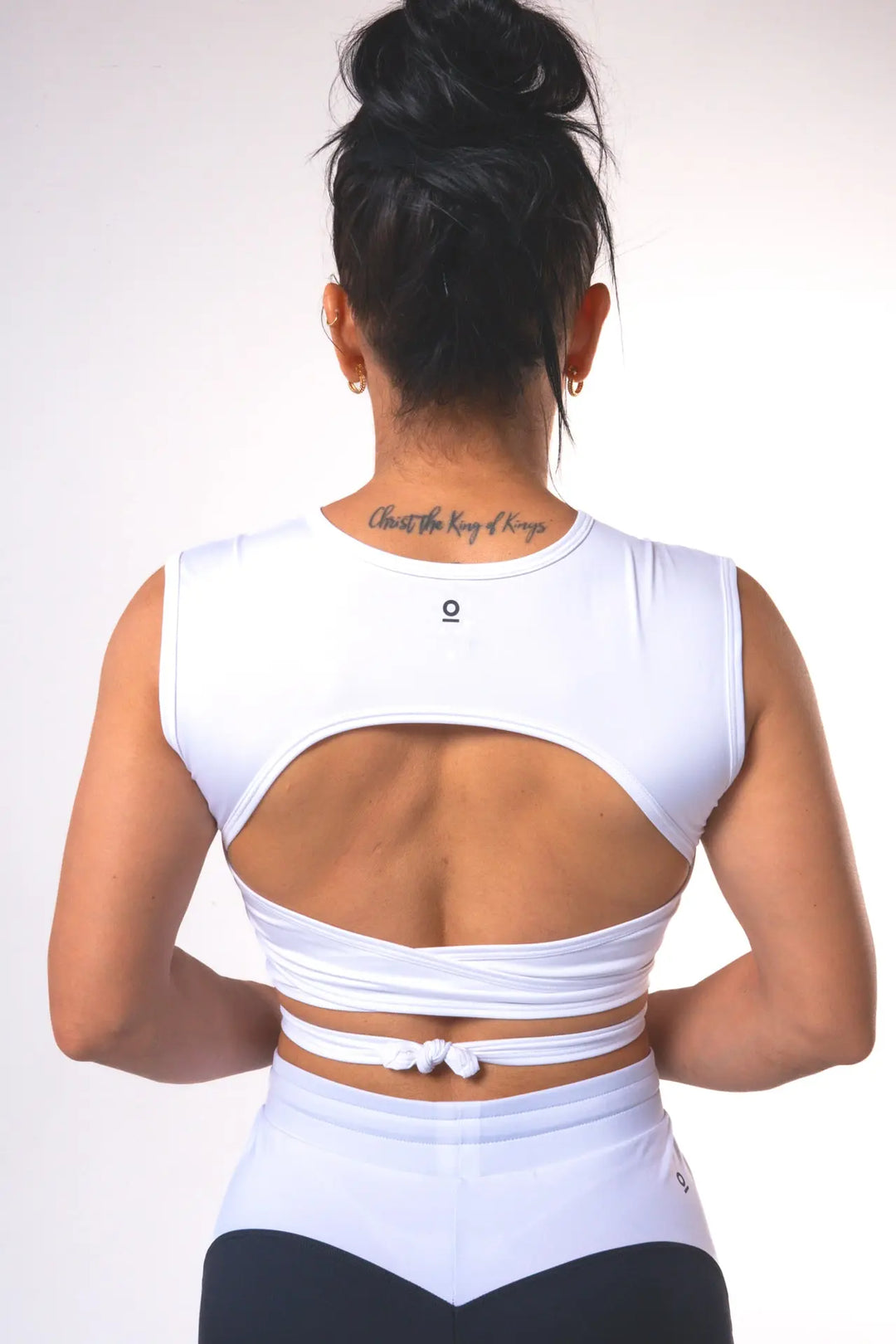 Woman wearing the Nikkie crop top functional of color white#color_white