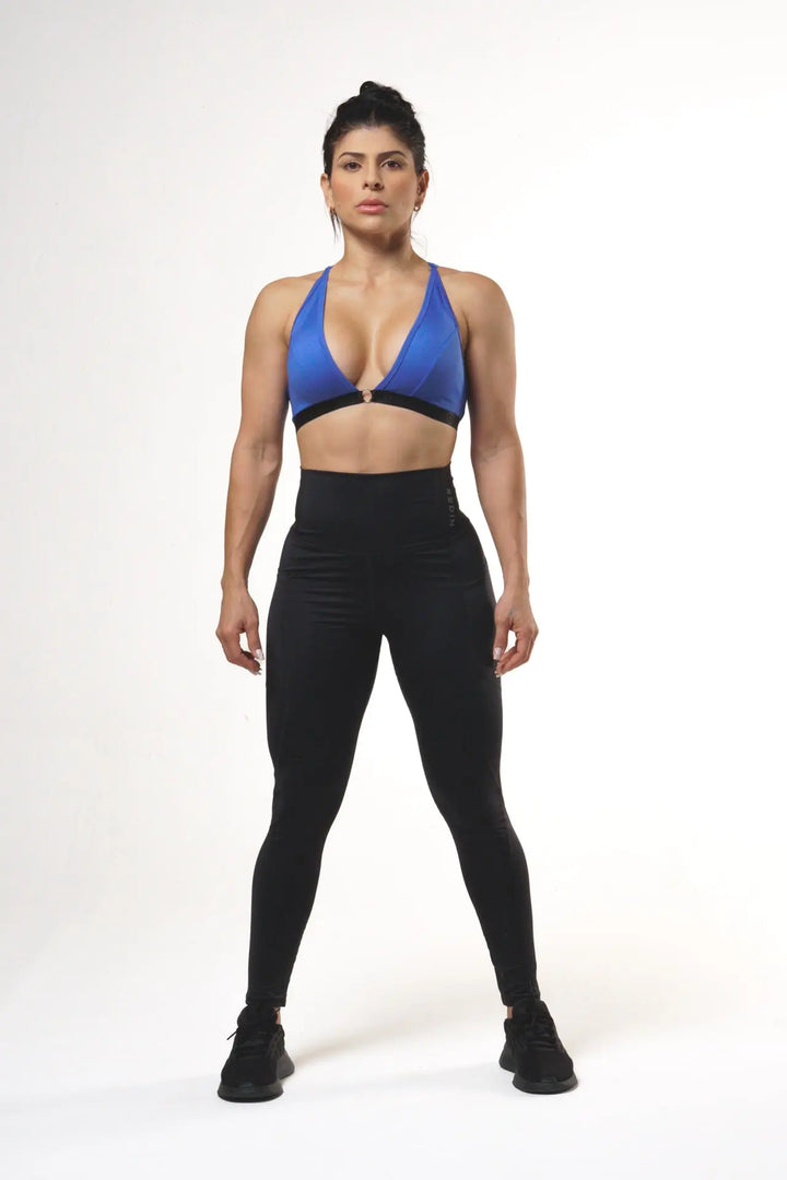 Woman wearing the Nola sport bra adjustable of color blue lolite#color_blue-lolite