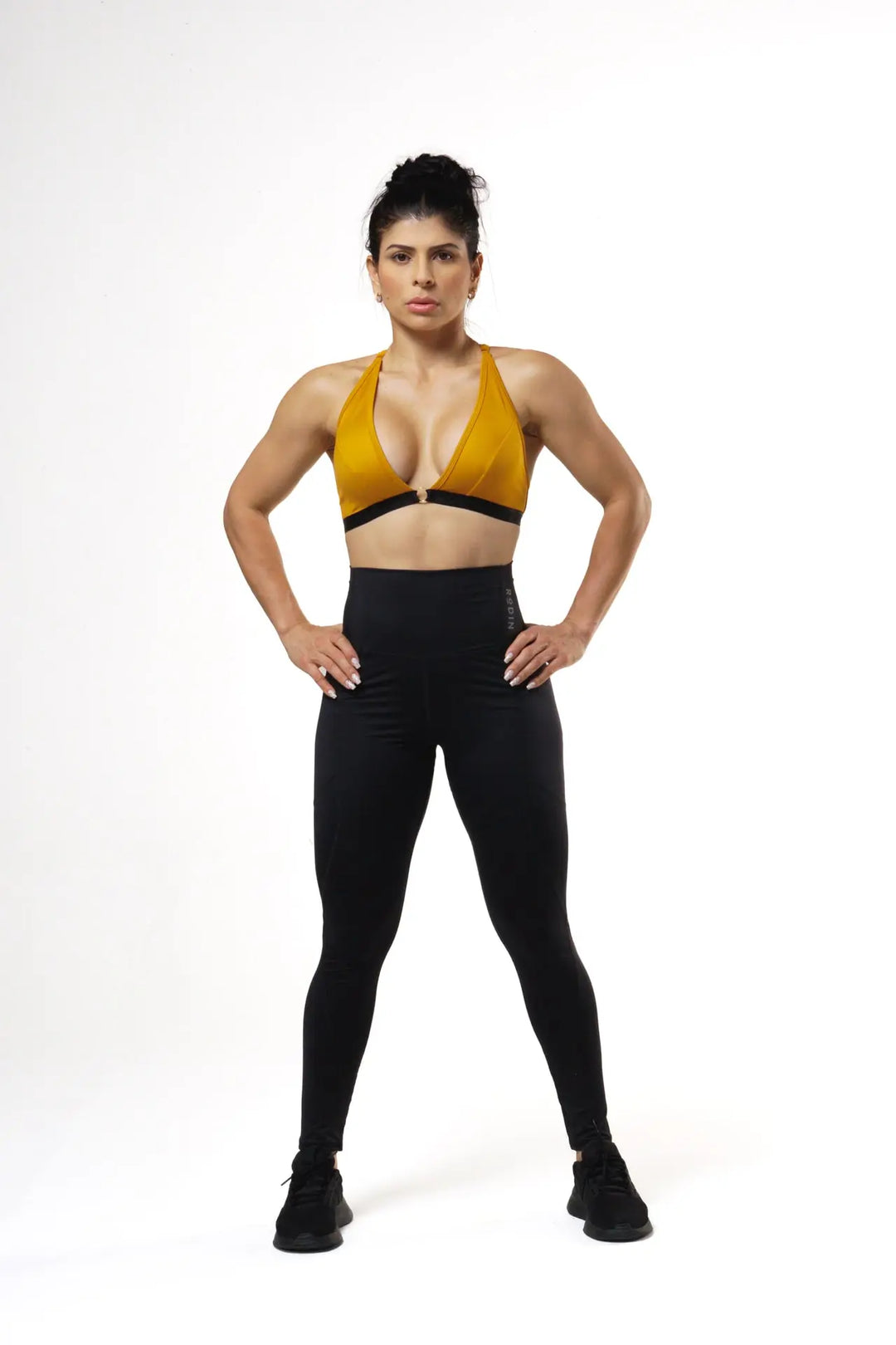 Woman wearing the Nola sport bra adjustable of color desert sun#color_desert-sun