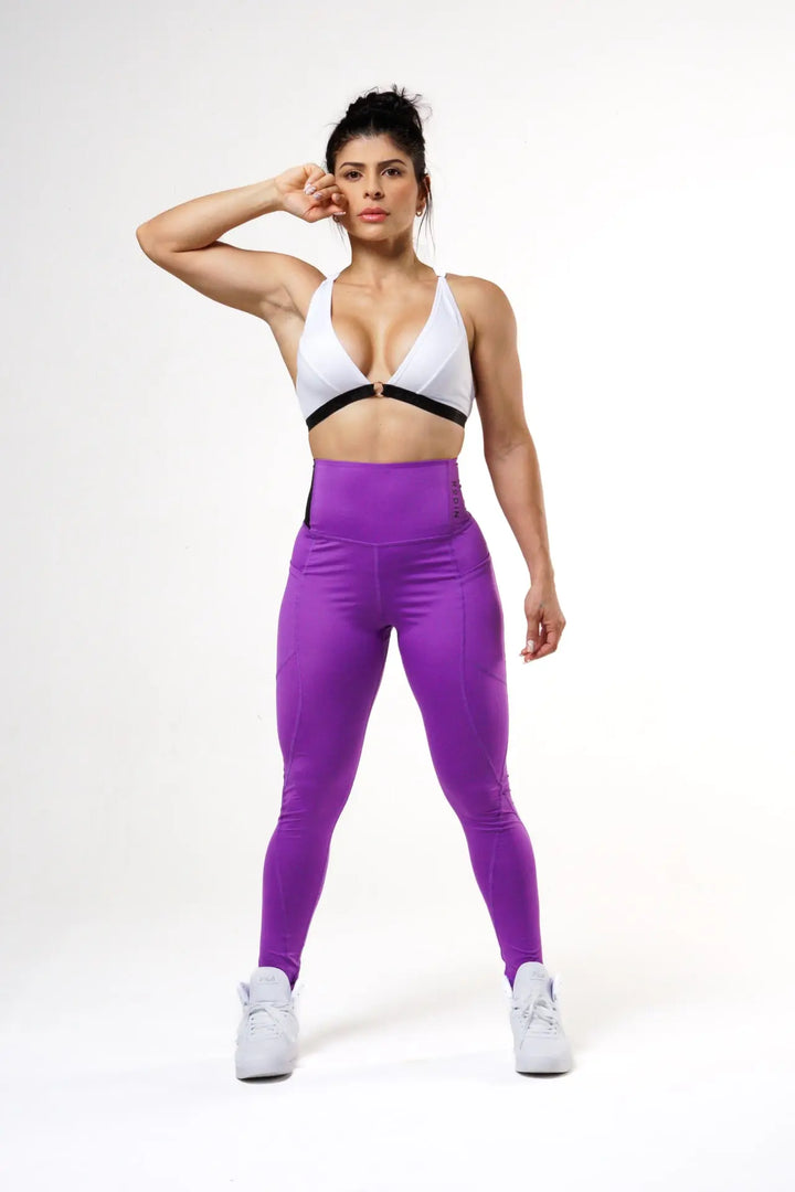 Woman wearing the Nola sport bra adjustable of color white#color_white