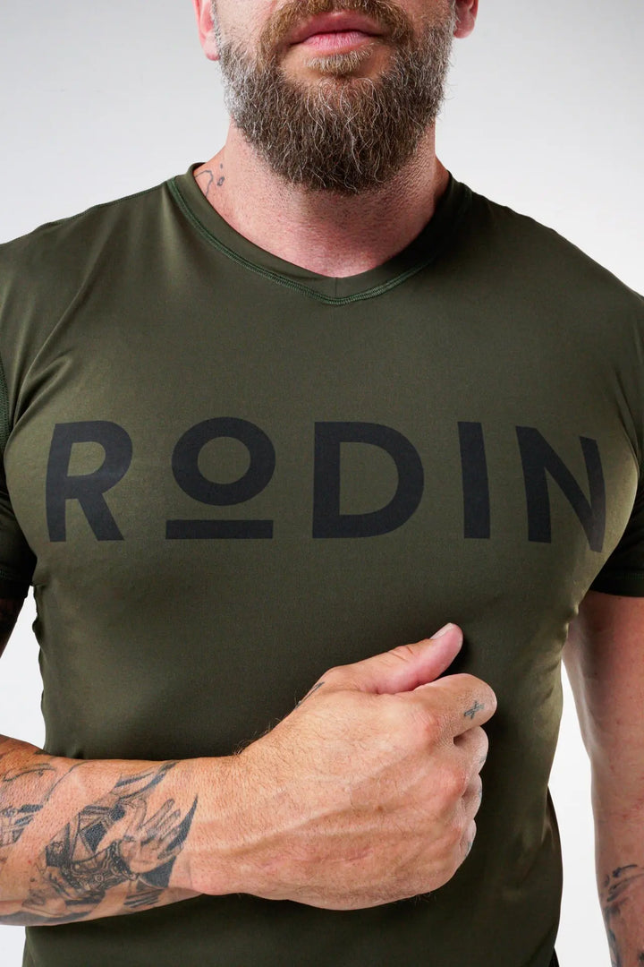 Man wearing the Odin functional athlete tee shirt of color riffle green#color_riffle-green