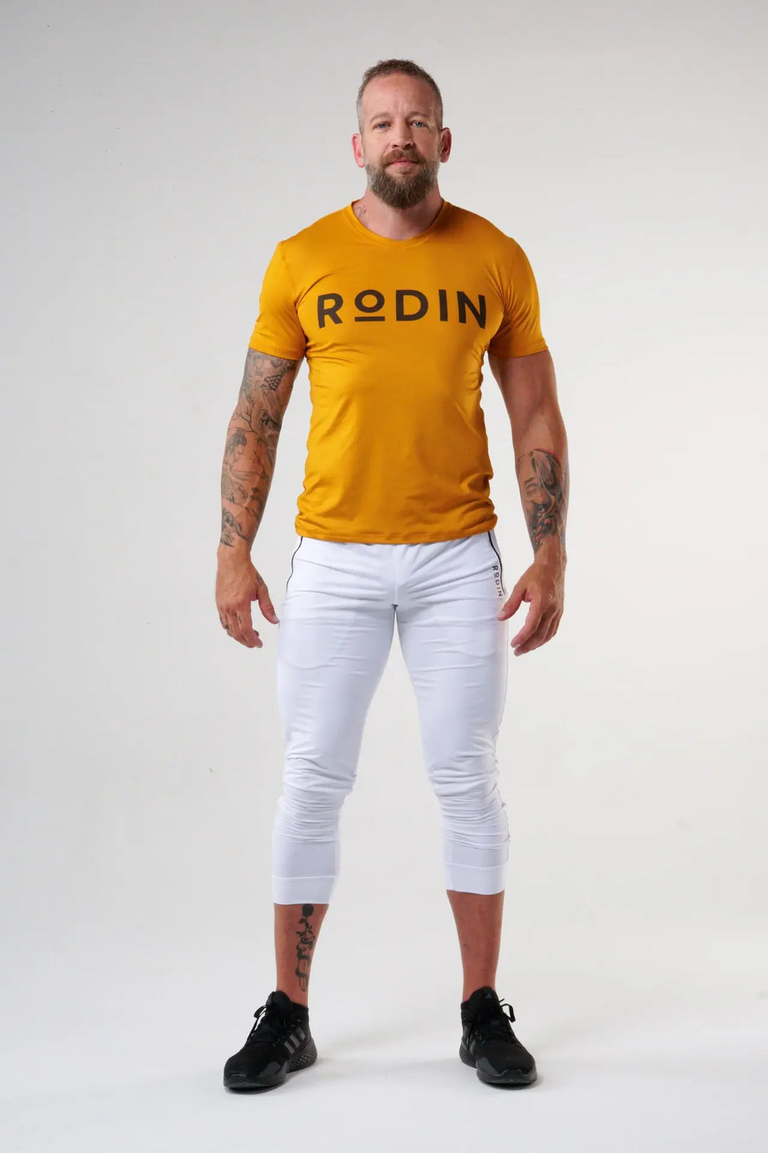 Man wearing the Odin functional athlete tee shirt of color desert sun#color_desert-sun