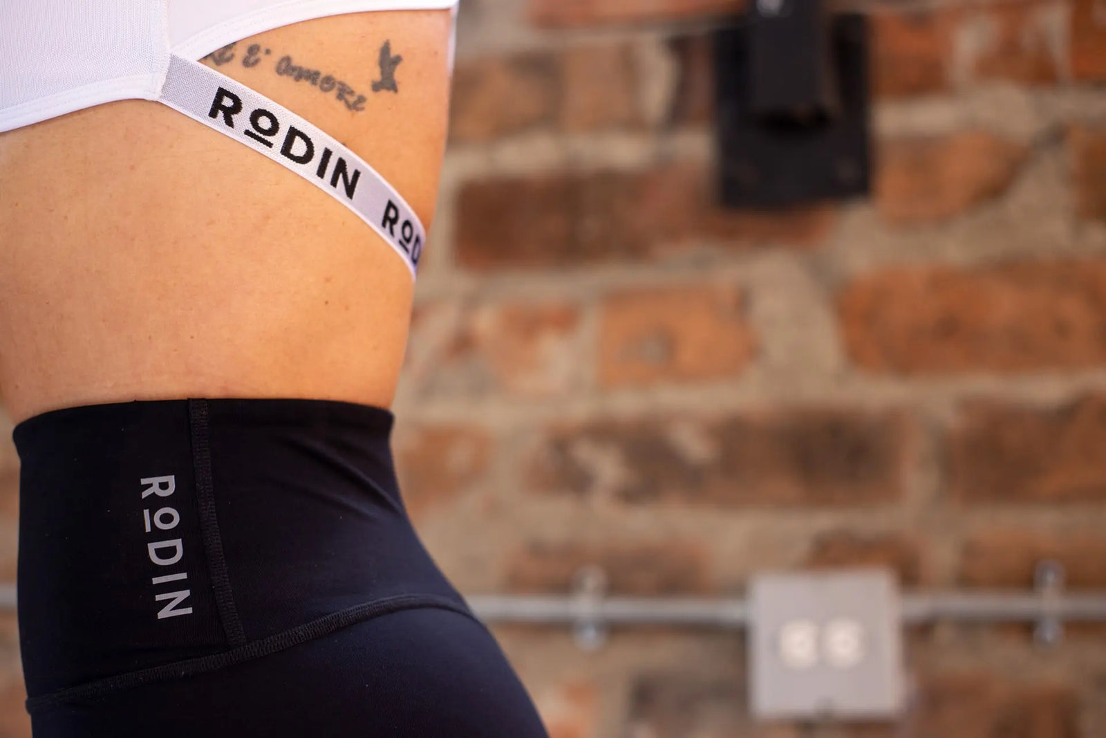 Woman in a white sports bra and black shorts 