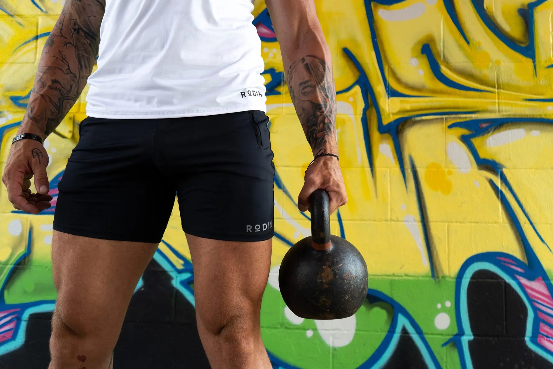 Man in sportswear holding a kettlebell