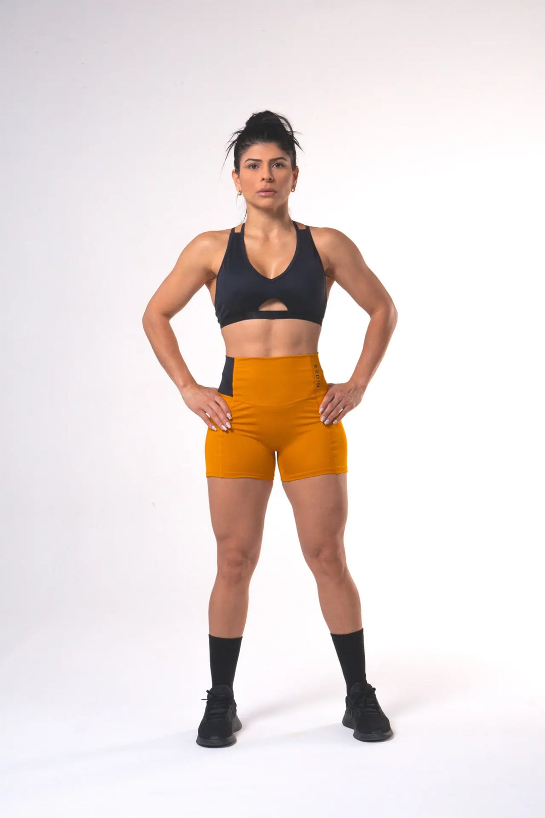 Woman wearing the Shasta adjustable sport bra of color black#color_black