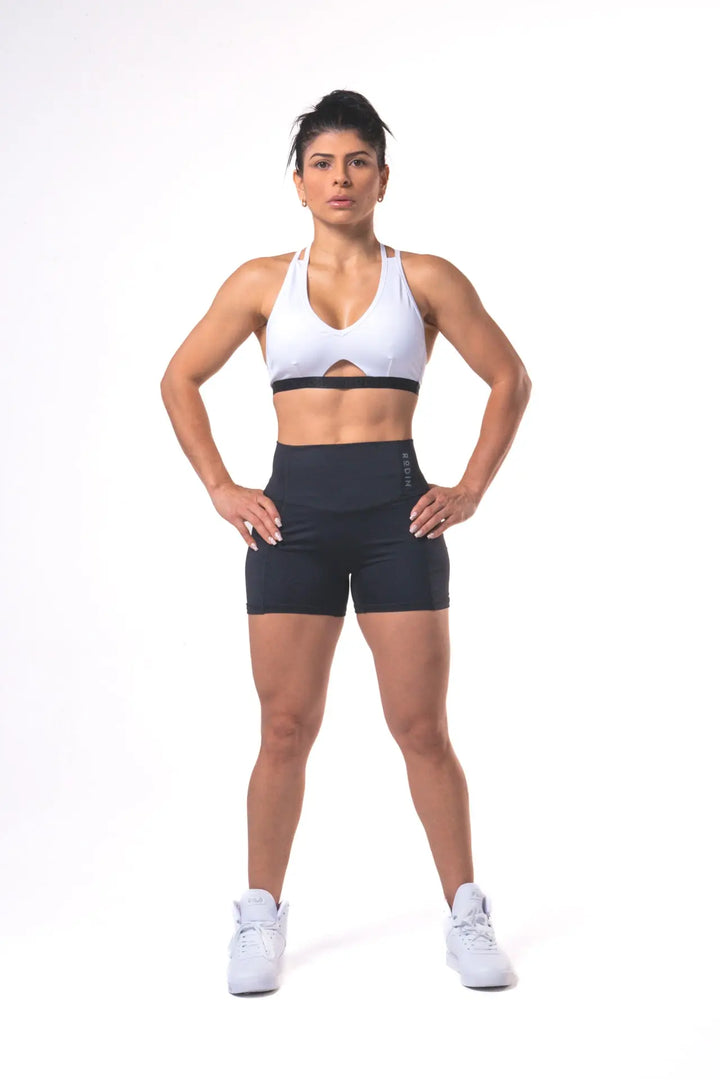 Woman wearing the Shasta adjustable sport bra of color white#color_white